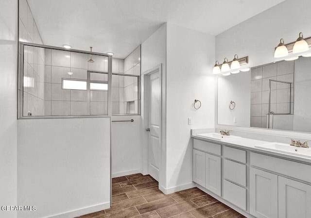 bathroom featuring walk in shower, double sink, and oversized vanity