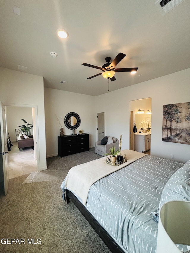 bedroom with a ceiling fan, light colored carpet, and visible vents