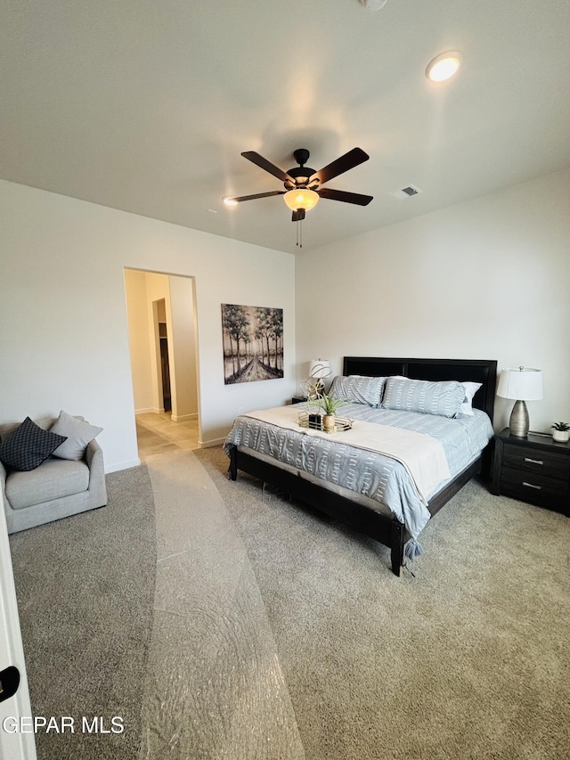 bedroom with visible vents, carpet, and a ceiling fan