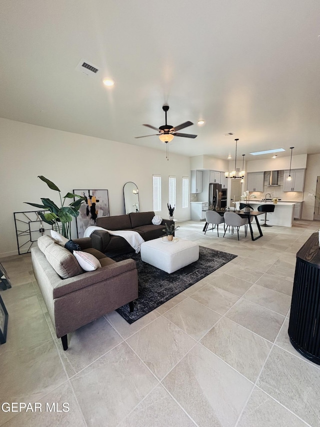 living area featuring ceiling fan, visible vents, and recessed lighting