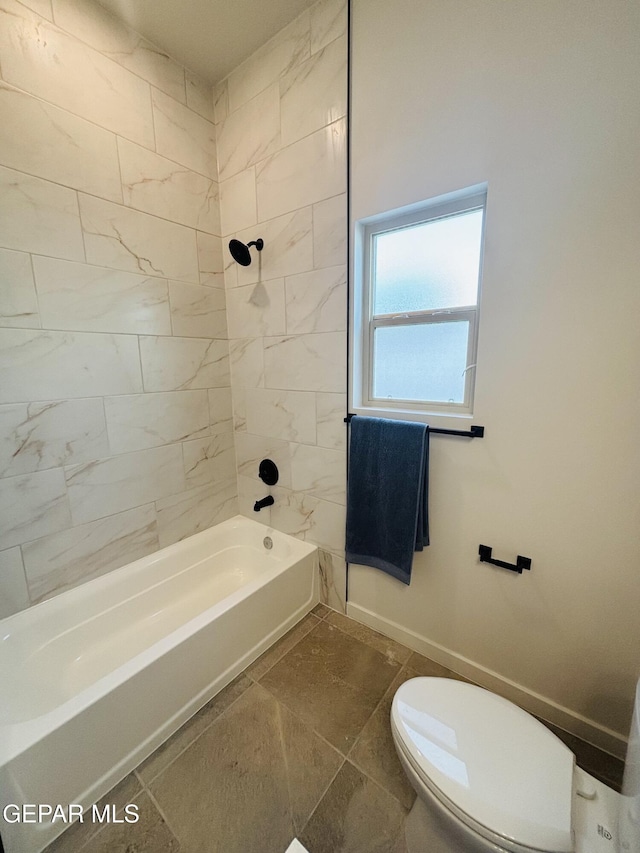 full bath with baseboards, toilet, and bathing tub / shower combination