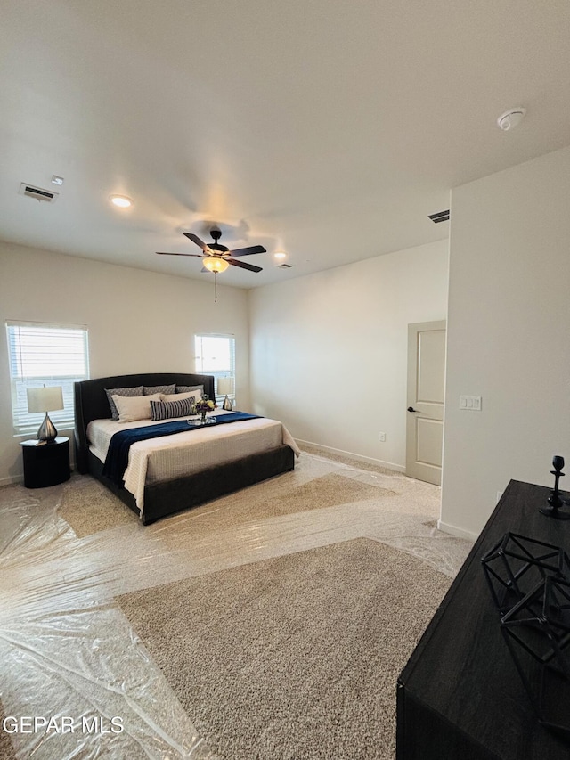 bedroom featuring baseboards, multiple windows, ceiling fan, and visible vents