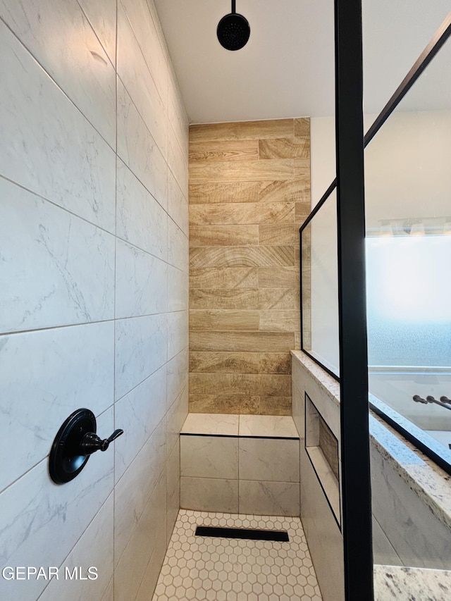 full bath featuring tiled shower