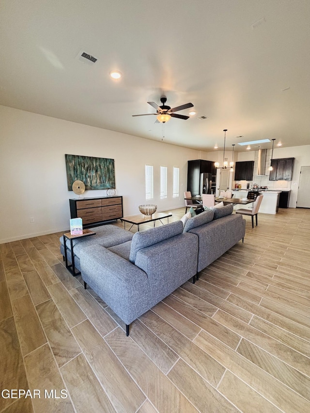 living room featuring visible vents, wood finish floors, recessed lighting, and a ceiling fan