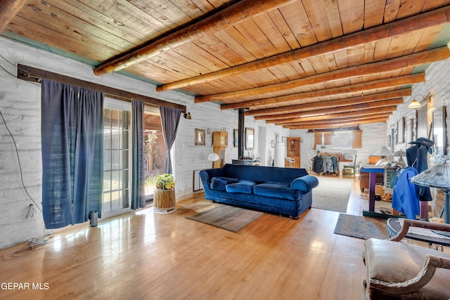 living room with light wood-type flooring, wood ceiling, and beamed ceiling