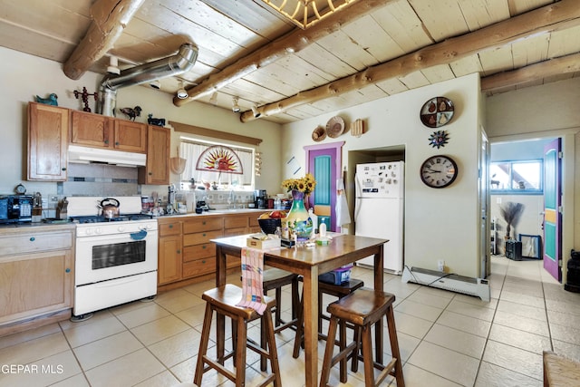 kitchen featuring white appliances, beam ceiling, and a healthy amount of sunlight