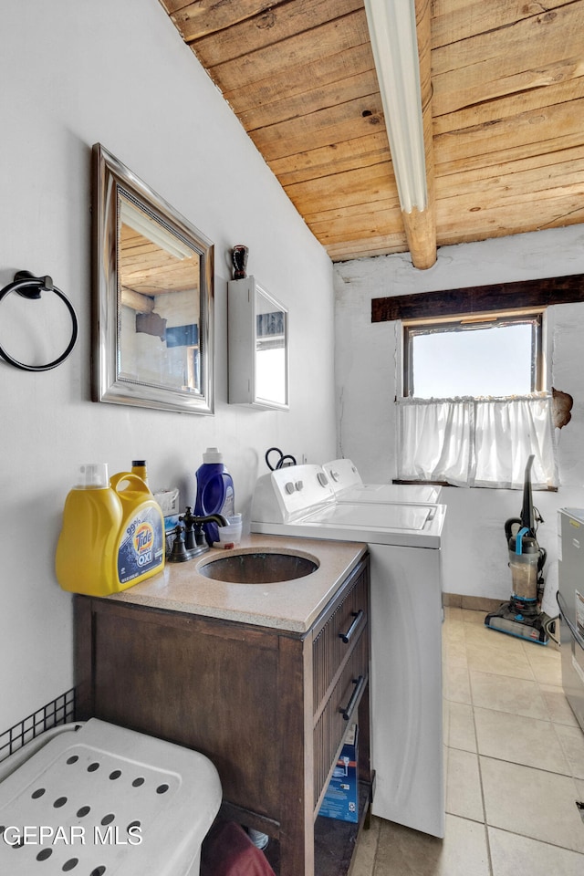 bathroom with washer and dryer, plenty of natural light, tile floors, and sink