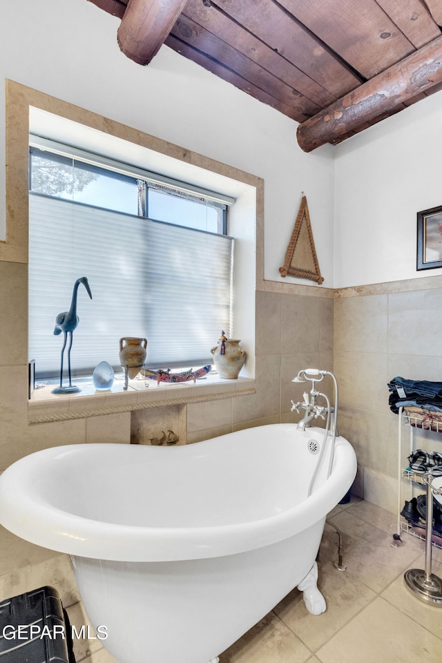 bathroom with tile walls, wood ceiling, a healthy amount of sunlight, and tile flooring