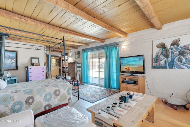 bedroom with light wood-type flooring, wooden ceiling, and beamed ceiling