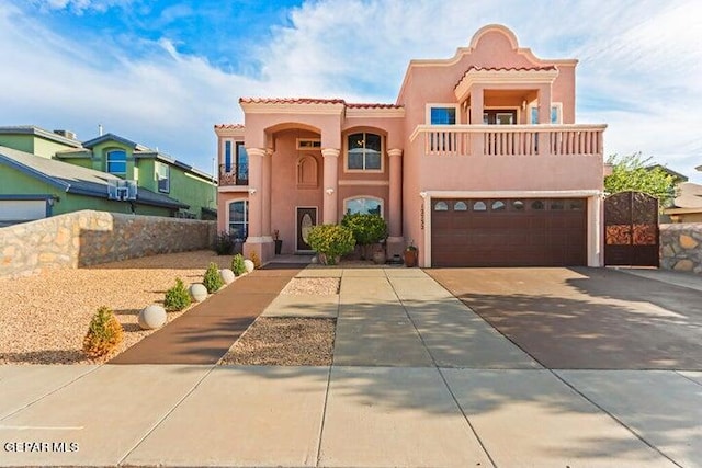 mediterranean / spanish-style house featuring a balcony and a garage