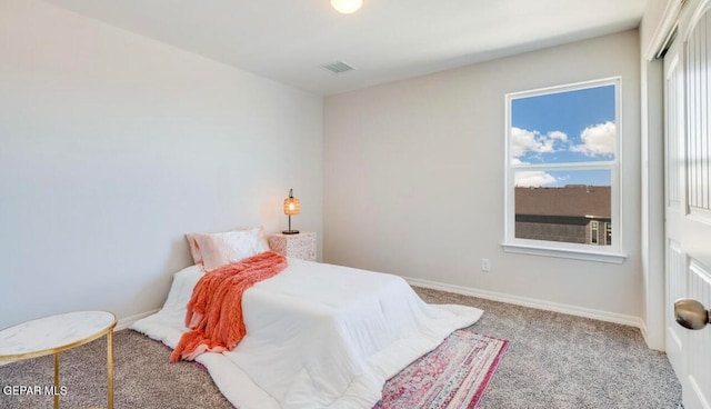 bedroom with light carpet and multiple windows