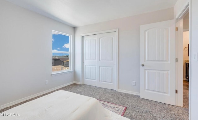 bedroom featuring light colored carpet and a closet