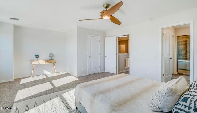 carpeted bedroom with connected bathroom and ceiling fan