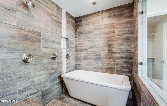 bathroom featuring tile walls and tiled shower