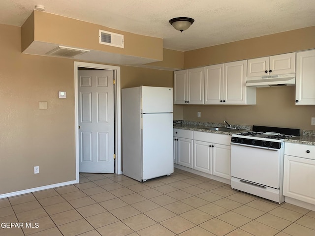 kitchen featuring white appliances, white cabinetry, light tile floors, and sink