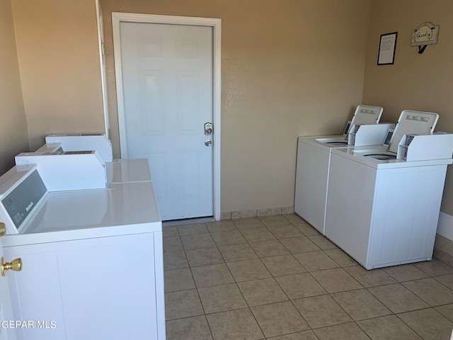 laundry area with light tile floors and washer and dryer