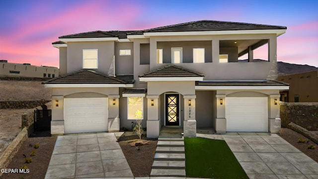 1848 Cimarron Park Dr, El Paso, TX 79911 - view of front of home with a tiled roof, a garage, stucco siding, and driveway