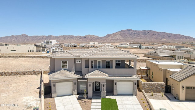 1848 Cimarron Park Dr, El Paso, TX 79911 - view of front of property with a garage, a mountain view, stucco siding, and concrete driveway