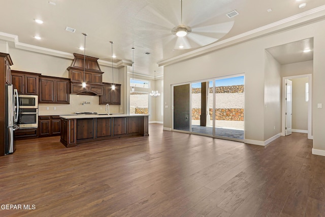1848 Cimarron Park Dr, El Paso, TX 79911 - kitchen featuring visible vents, light countertops, premium range hood, open floor plan, and stainless steel appliances