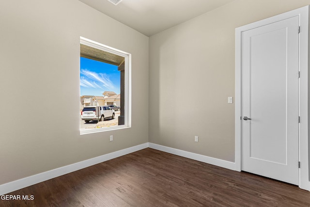1848 Cimarron Park Dr, El Paso, TX 79911 - unfurnished room with baseboards and dark wood-style floors