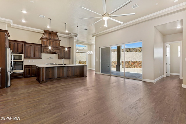 1848 Cimarron Park Dr, El Paso, TX 79911 - kitchen featuring custom exhaust hood, open floor plan, a center island with sink, light countertops, and appliances with stainless steel finishes