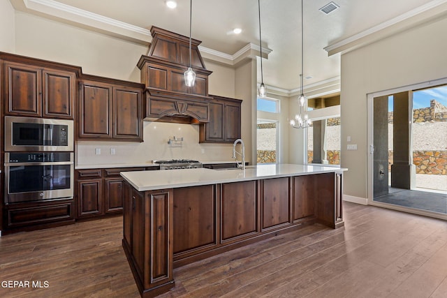 1848 Cimarron Park Dr, El Paso, TX 79911 - kitchen with crown molding, appliances with stainless steel finishes, dark wood-style floors, and light countertops