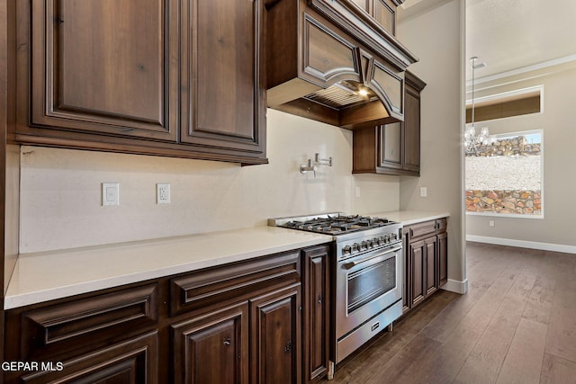 1848 Cimarron Park Dr, El Paso, TX 79911 - kitchen featuring dark brown cabinetry, custom exhaust hood, and high end stainless steel range oven