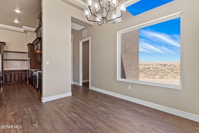 1848 Cimarron Park Dr, El Paso, TX 79911 - unfurnished dining area featuring crown molding, dark wood-style flooring, a notable chandelier, baseboards, and visible vents