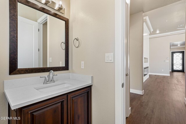 1848 Cimarron Park Dr, El Paso, TX 79911 - bathroom with baseboards, vanity, and wood finished floors