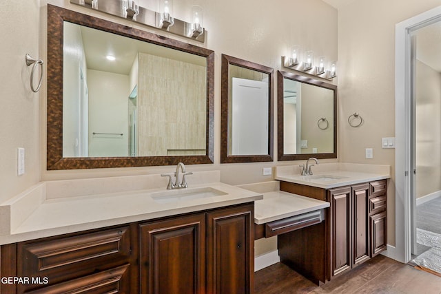 1848 Cimarron Park Dr, El Paso, TX 79911 - full bathroom featuring double vanity, a sink, and wood finished floors
