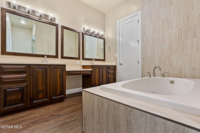 1848 Cimarron Park Dr, El Paso, TX 79911 - bathroom featuring wood finished floors, a sink, a bathtub, and double vanity