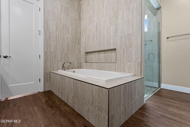 1848 Cimarron Park Dr, El Paso, TX 79911 - full bathroom featuring wood finished floors, a garden tub, and a stall shower