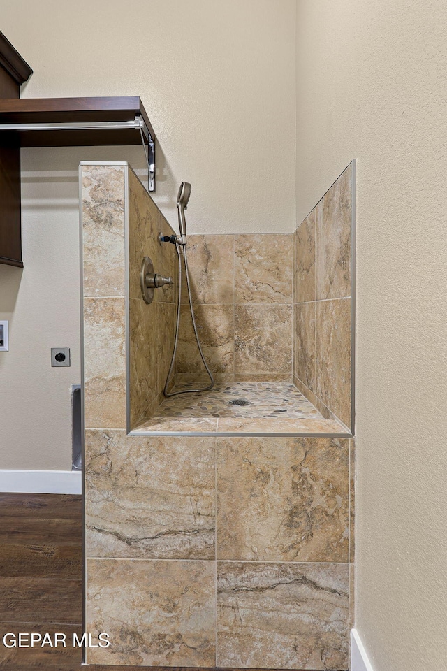 1848 Cimarron Park Dr, El Paso, TX 79911 - room details with baseboards, wood finished floors, and a tile shower