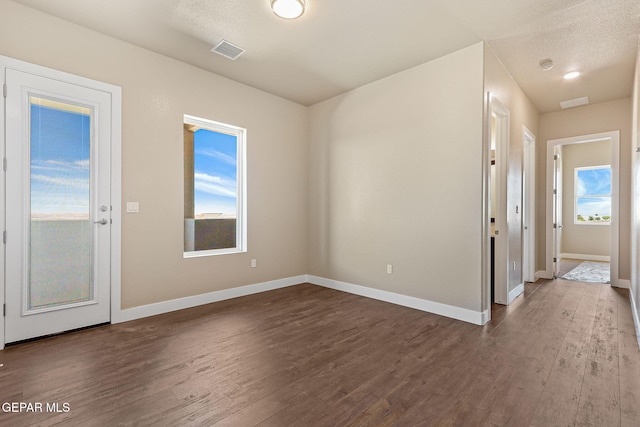 1848 Cimarron Park Dr, El Paso, TX 79911 - spare room featuring baseboards, dark wood finished floors, and visible vents