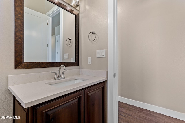 1848 Cimarron Park Dr, El Paso, TX 79911 - bathroom with baseboards, wood finished floors, and vanity
