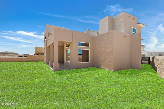 1848 Cimarron Park Dr, El Paso, TX 79911 - rear view of property featuring stucco siding, a yard, and fence
