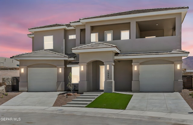 1848 Cimarron Park Dr, El Paso, TX 79911 - view of front of home featuring a tiled roof, an attached garage, driveway, and stucco siding