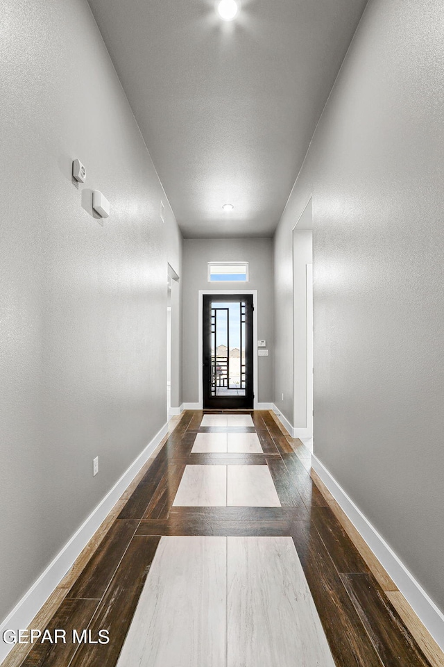 doorway with dark hardwood / wood-style flooring