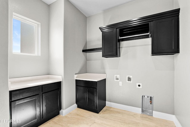 laundry room featuring hookup for a washing machine, cabinets, and electric dryer hookup