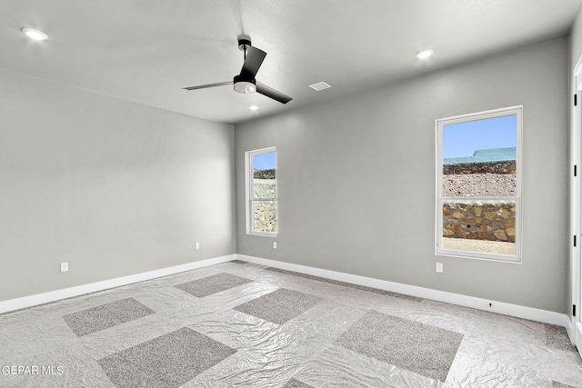 empty room with a wealth of natural light and ceiling fan