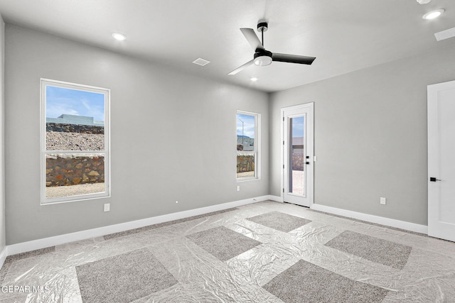 empty room featuring ceiling fan and light colored carpet