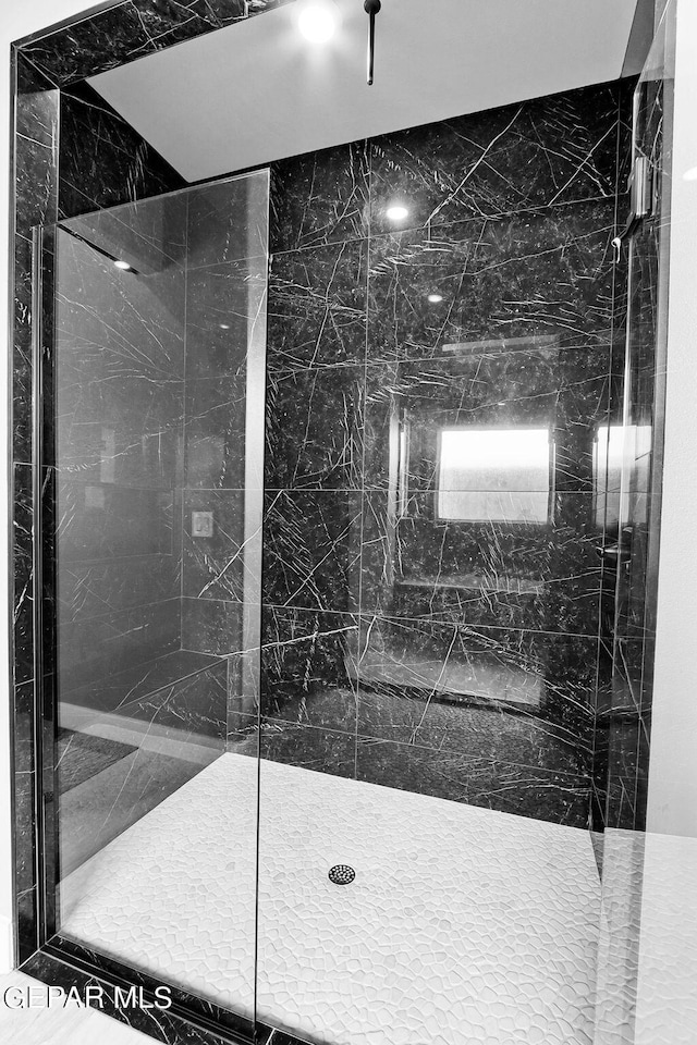 bathroom with tiled shower