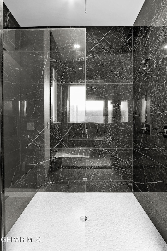 bathroom with tiled shower