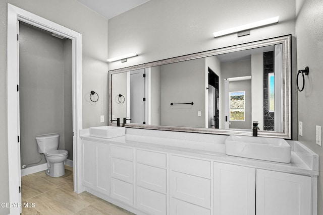 bathroom with vanity, tile patterned flooring, and toilet