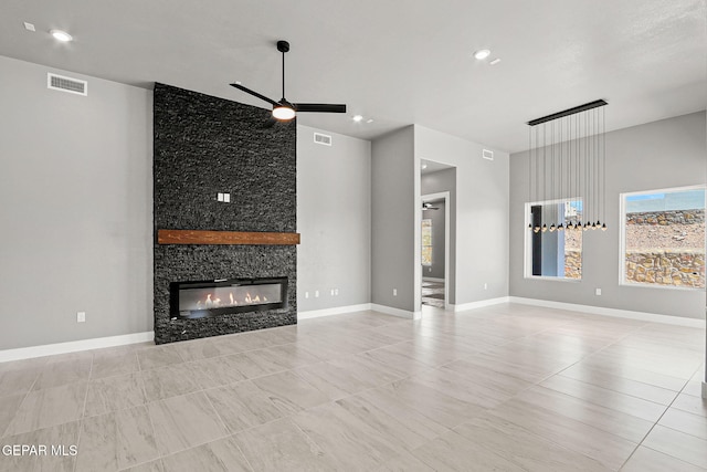 unfurnished living room featuring a fireplace and ceiling fan