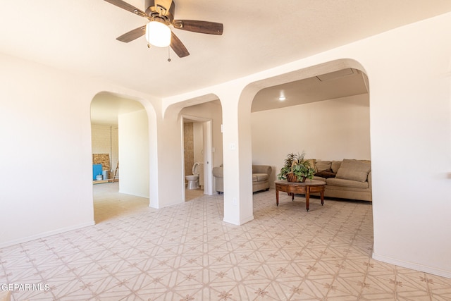 spare room with ceiling fan and light tile floors