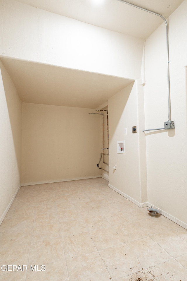 interior space featuring electric dryer hookup, washer hookup, and light tile floors