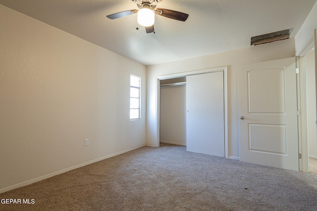 unfurnished bedroom with a closet, carpet floors, and ceiling fan