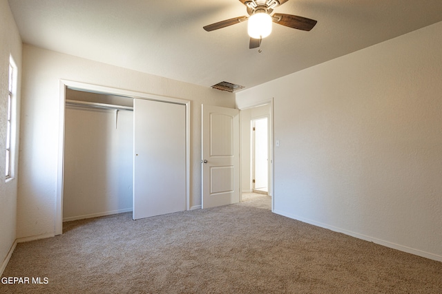 unfurnished bedroom with carpet, ceiling fan, and a closet