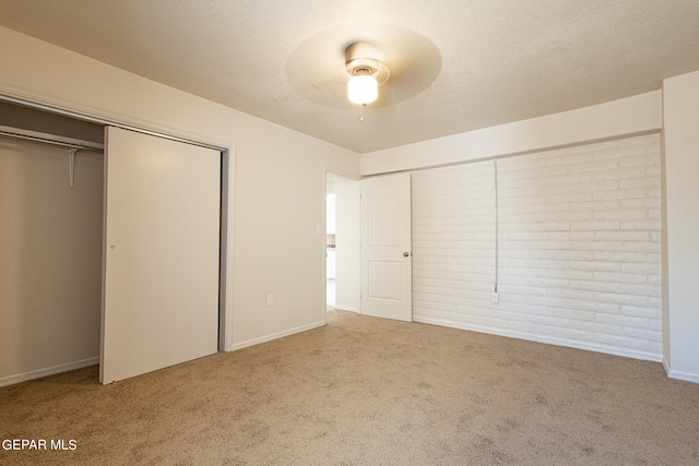 unfurnished bedroom with a closet, carpet floors, and ceiling fan